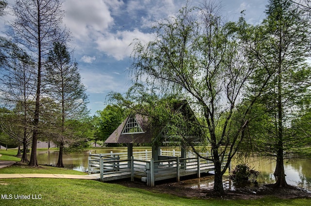 exterior space with a water view and a yard