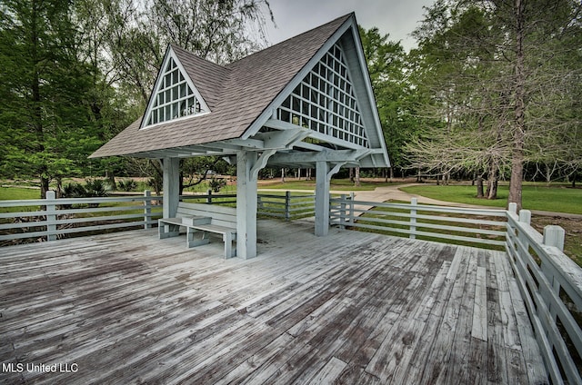 wooden terrace featuring a yard