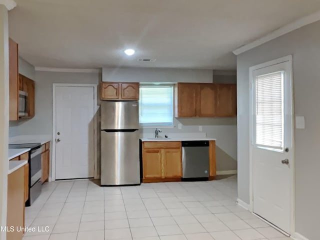 6525 Yorkshire Rd, Horn Lake, MS 38637 - kitchen featuring appliances with stainless steel finishes, light countertops, healthy amount of natural light, brown cabinetry, and recessed lighting