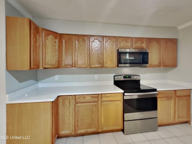 6525 Yorkshire Rd, Horn Lake, MS 38637 - kitchen featuring stainless steel appliances, light countertops, and light tile patterned floors