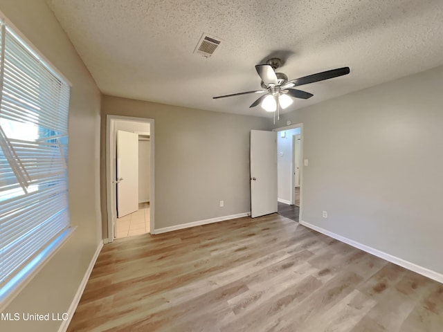 6525 Yorkshire Rd, Horn Lake, MS 38637 - unfurnished bedroom featuring wood finished floors, a textured ceiling, baseboards, and a ceiling fan