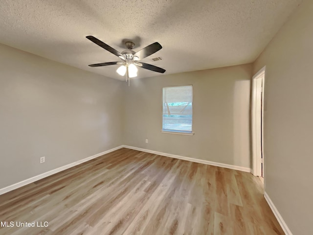6525 Yorkshire Rd, Horn Lake, MS 38637 - unfurnished room with a textured ceiling, wood finished floors, a ceiling fan, and baseboards