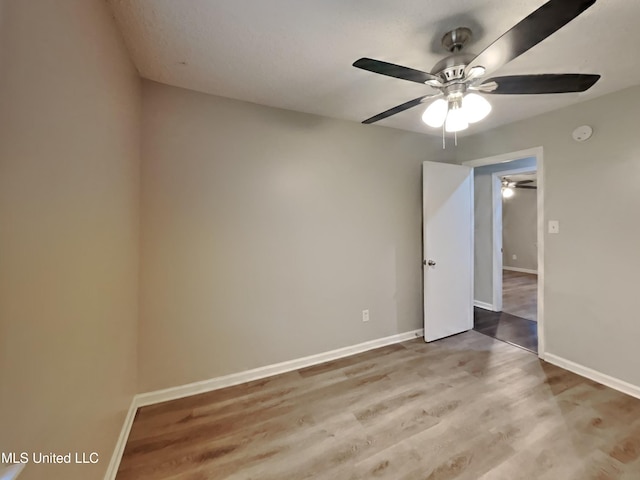6525 Yorkshire Rd, Horn Lake, MS 38637 - spare room featuring a ceiling fan, baseboards, wood finished floors, and a smoke detector