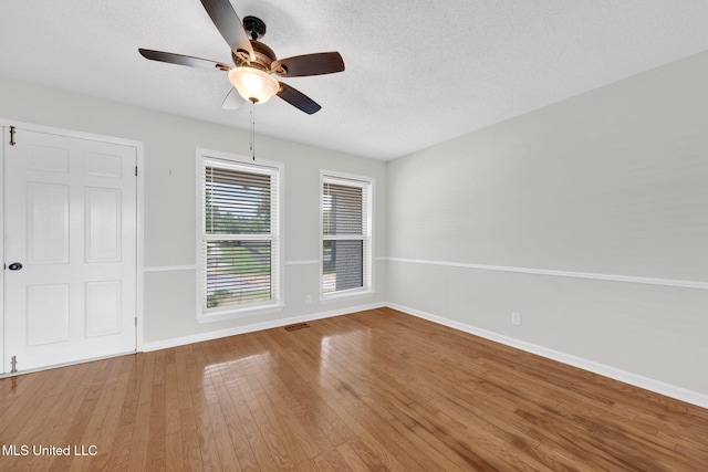 8279 Dunn Ln, Olive Branch, MS 38654 - empty room featuring a ceiling fan, hardwood / wood-style flooring, and a textured ceiling