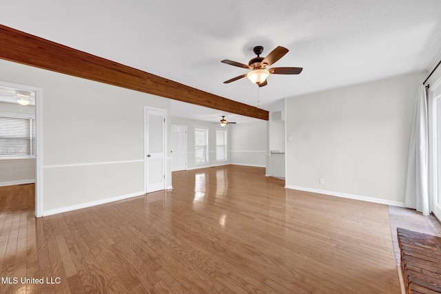 8279 Dunn Ln, Olive Branch, MS 38654 - unfurnished living room featuring a ceiling fan, plenty of natural light, light wood finished floors, and beam ceiling