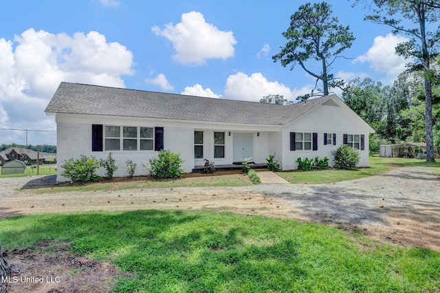 8279 Dunn Ln, Olive Branch, MS 38654 - ranch-style house with brick siding, a front lawn, and a shingled roof