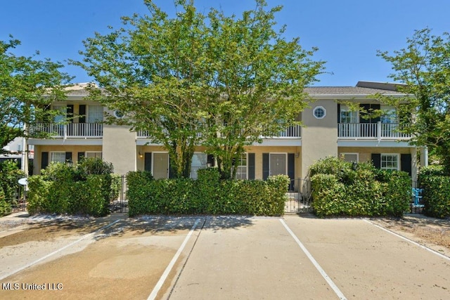 view of front of home featuring uncovered parking and stucco siding