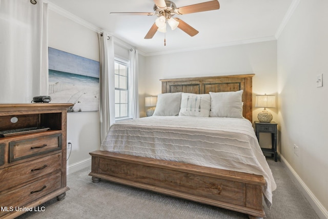 bedroom with ceiling fan, carpet floors, ornamental molding, and baseboards