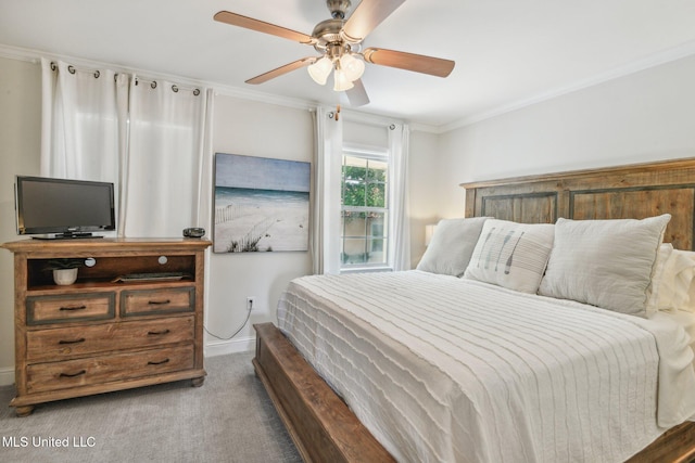 carpeted bedroom featuring ornamental molding and a ceiling fan