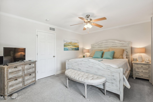 carpeted bedroom featuring ceiling fan, visible vents, and ornamental molding