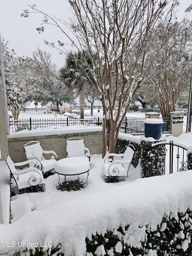 yard layered in snow featuring fence