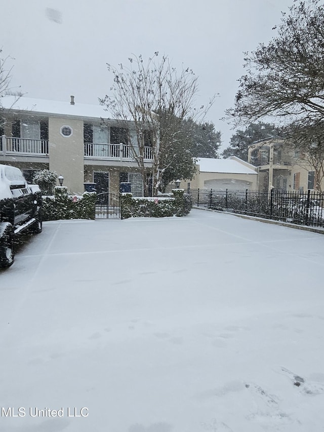 yard layered in snow with fence