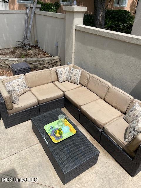 view of patio with fence and outdoor lounge area