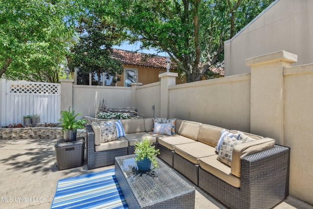 view of patio featuring outdoor lounge area and fence