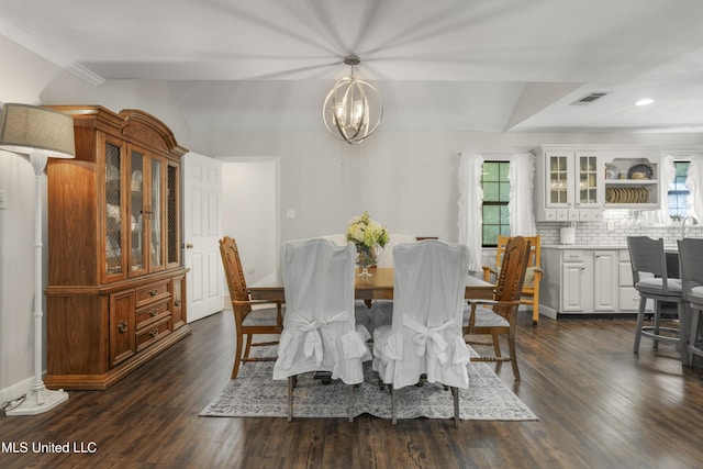 dining space with visible vents, vaulted ceiling, dark wood-style floors, and a notable chandelier
