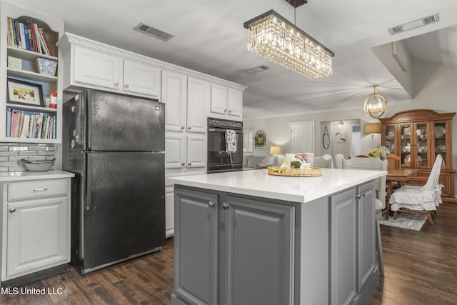 kitchen with gray cabinets, visible vents, black appliances, and a notable chandelier