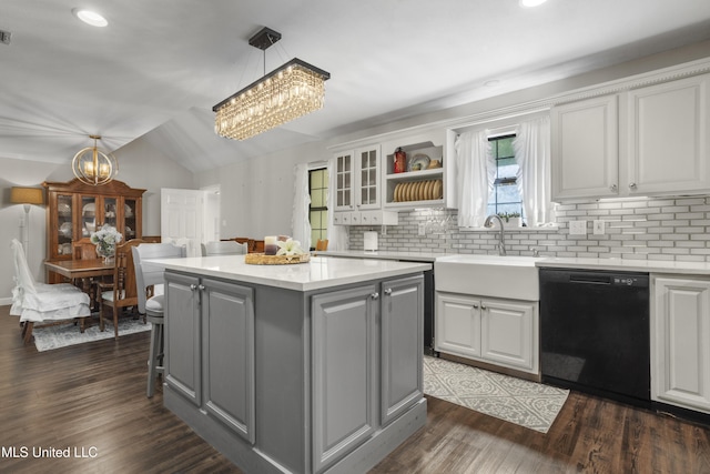 kitchen with a notable chandelier, a sink, dishwasher, a center island, and gray cabinetry