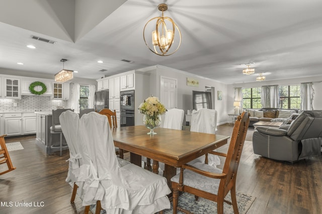 dining space featuring an inviting chandelier, visible vents, and a healthy amount of sunlight