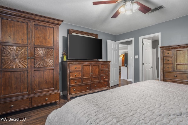bedroom with baseboards, visible vents, ceiling fan, and dark wood-type flooring