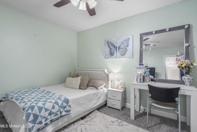 carpeted bedroom featuring baseboards and a ceiling fan