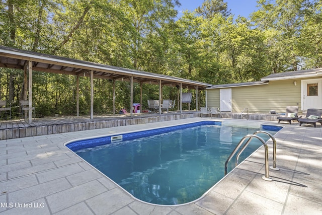 outdoor pool with a patio area
