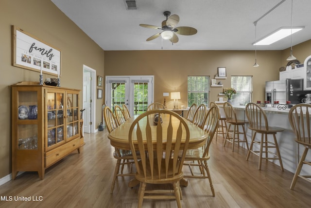 dining space featuring ceiling fan, light wood-style flooring, and visible vents
