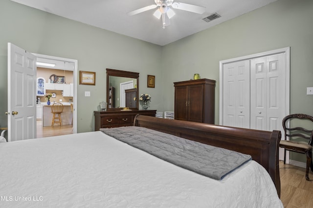 bedroom with ceiling fan, a closet, light wood-style flooring, and visible vents