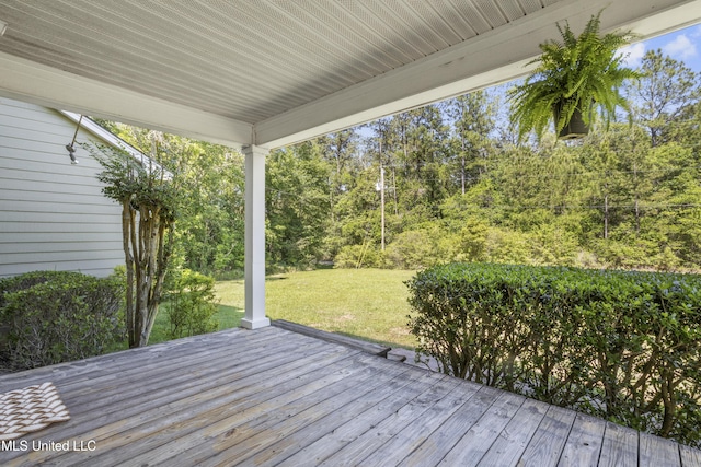 wooden deck with a lawn