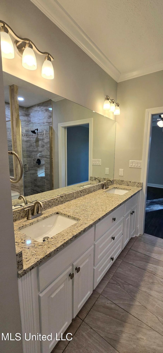 bathroom featuring wood-type flooring, a textured ceiling, an enclosed shower, vanity, and ornamental molding