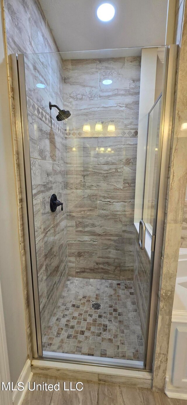 bathroom featuring an enclosed shower