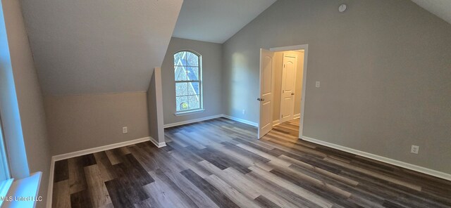 bonus room featuring dark hardwood / wood-style flooring and vaulted ceiling