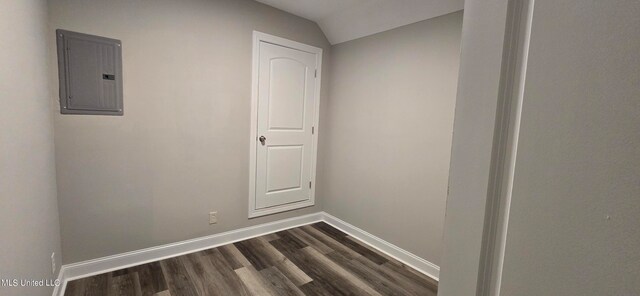 interior space with lofted ceiling, electric panel, and dark hardwood / wood-style flooring