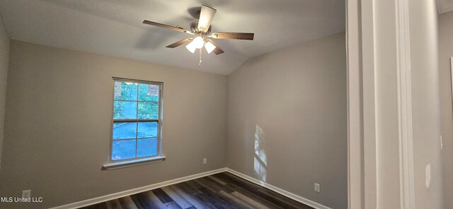 empty room with dark wood-type flooring, ceiling fan, and vaulted ceiling