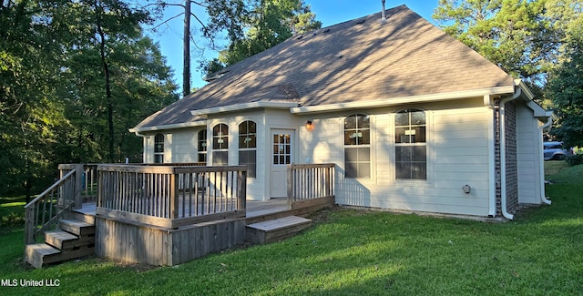 back of property with a yard and a deck