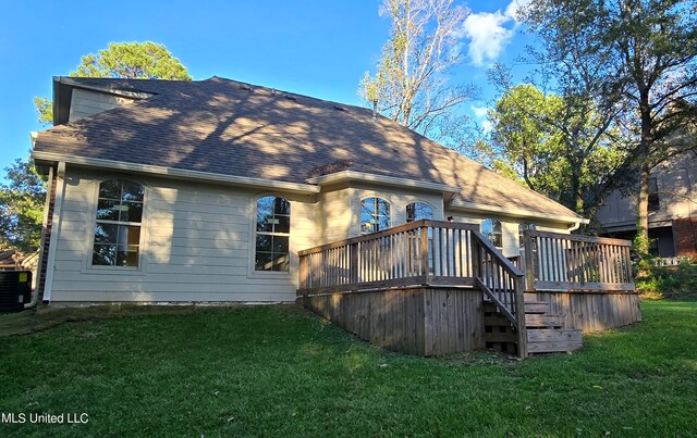 back of property with cooling unit, a deck, and a yard