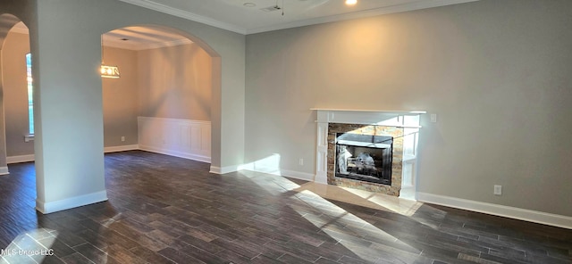 unfurnished living room with ornamental molding and dark wood-type flooring