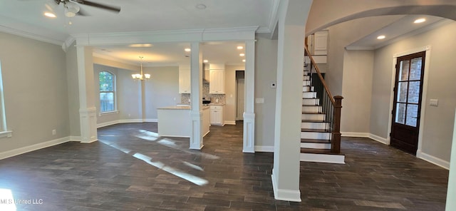 entryway with ornamental molding, ceiling fan, ornate columns, and dark hardwood / wood-style flooring