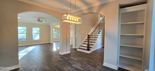 entrance foyer featuring ceiling fan, ornamental molding, and dark hardwood / wood-style floors