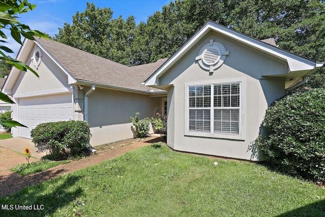 single story home with a front yard and a garage