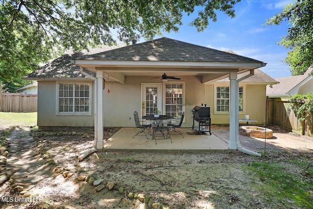 rear view of property with a patio area, a fire pit, and ceiling fan