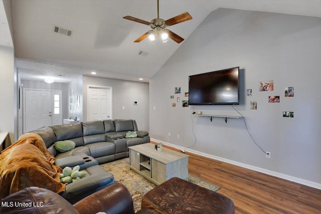 living room with hardwood / wood-style flooring, high vaulted ceiling, and ceiling fan