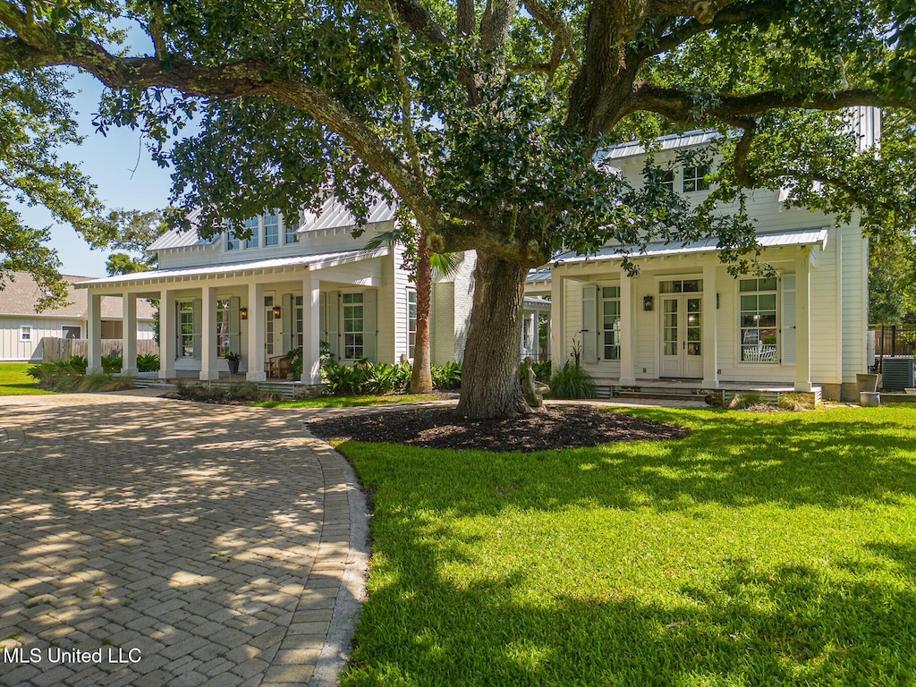 view of front of home featuring a porch, central AC, and a front lawn