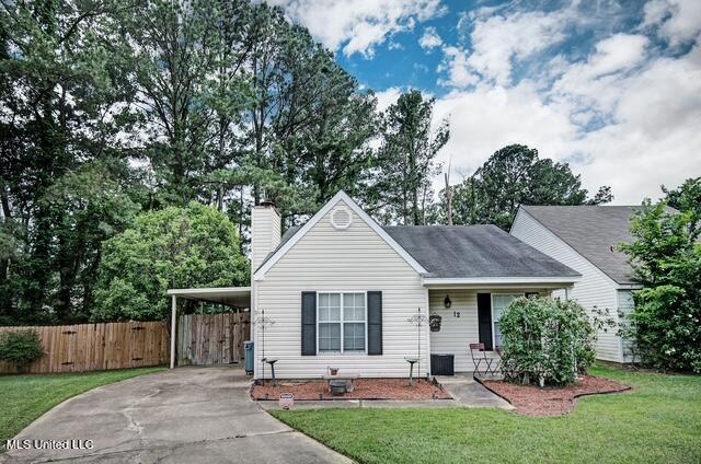 12 S Brandy Ct, Brandon, MS 39047 - view of front facade featuring driveway, a chimney, and an attached carport