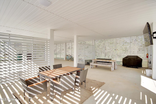 view of patio with outdoor dining area and grilling area