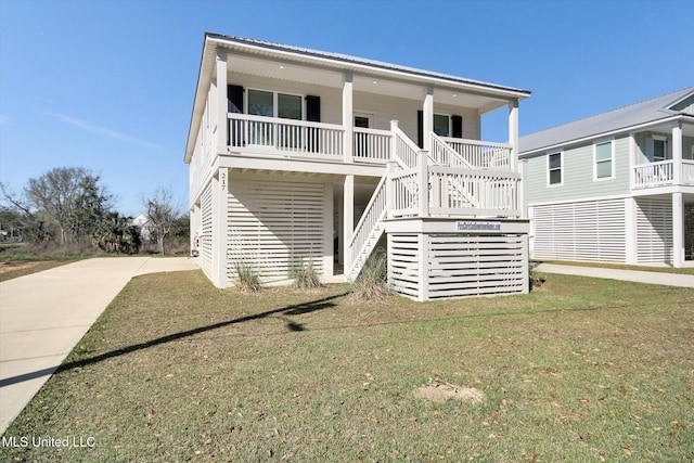 view of front of property with a porch, stairs, and a front lawn