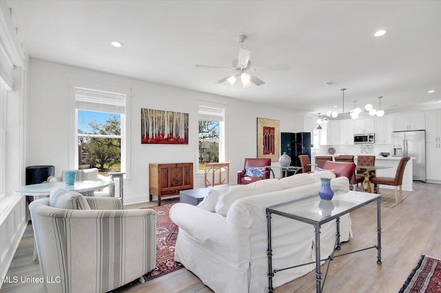 living room featuring light wood-style flooring, recessed lighting, and ceiling fan