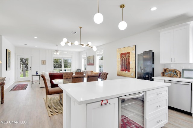 kitchen featuring light wood-type flooring, visible vents, wine cooler, light countertops, and dishwasher