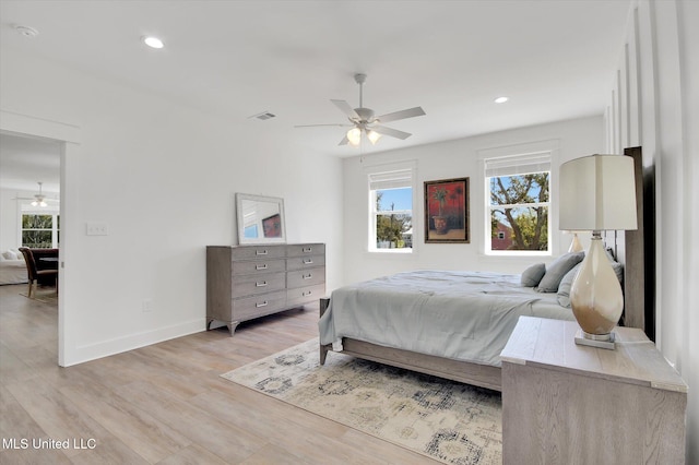 bedroom featuring light wood-type flooring, visible vents, baseboards, and recessed lighting