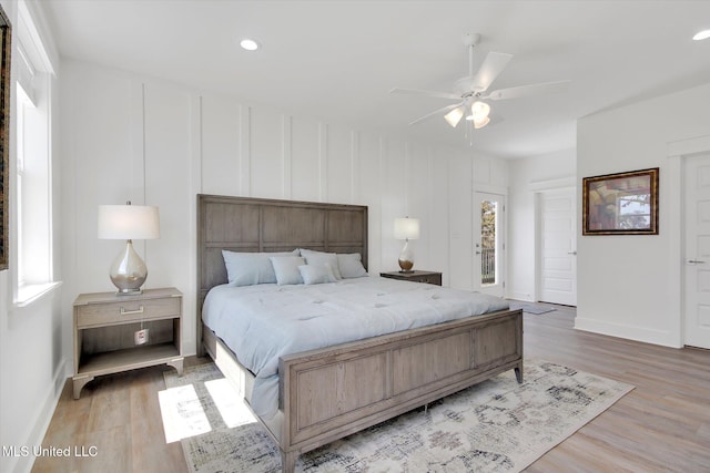 bedroom with light wood finished floors, recessed lighting, and baseboards