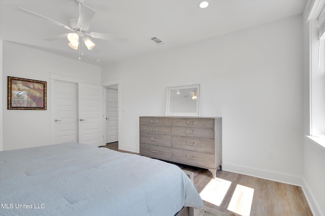 bedroom with visible vents, a ceiling fan, wood finished floors, recessed lighting, and baseboards